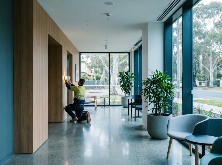 Maintenance professional at work in a clean apartment-building common area